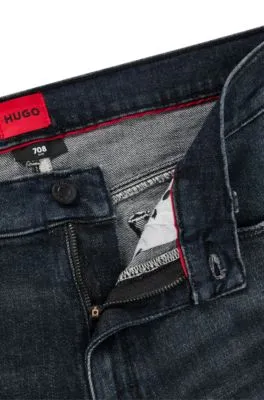 Vaqueros slim fit de denim elástico con efecto desgastado